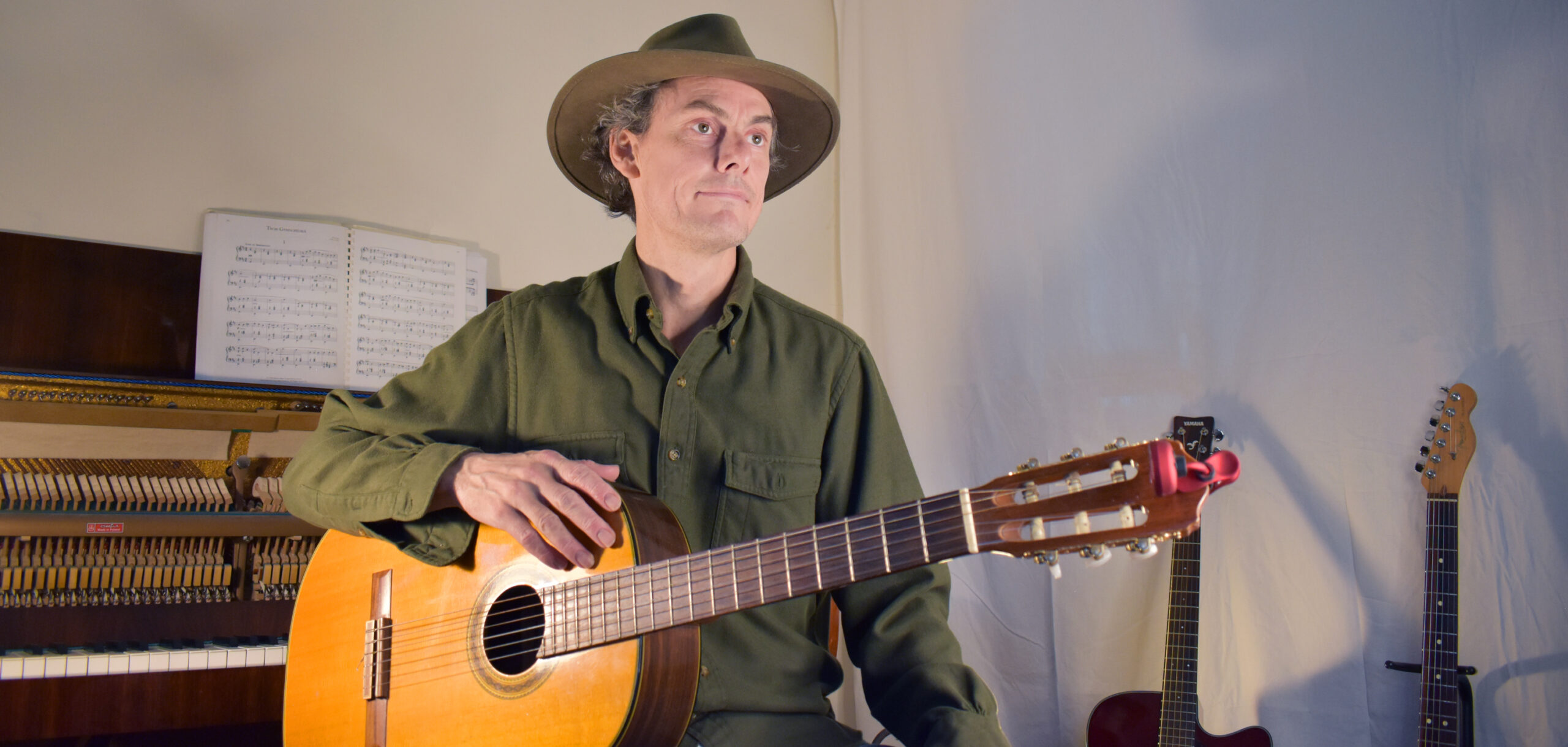 Photo of a man holding a guitar